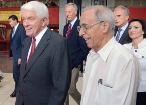 Thomas J. Donohue walking with Roberto de Armas (in a guayabera), head of the U.S. desk at the Cuban Foreign Ministry. In background in a navy blue suit is Steve Van Andel.