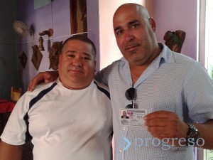 Idalberto Ramírez, owner of the restaurant El Campesino, shows off his identity card.