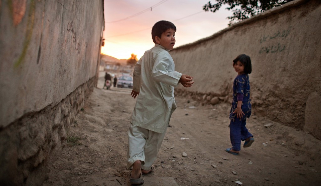 Mehran plays in the alley outside her home.