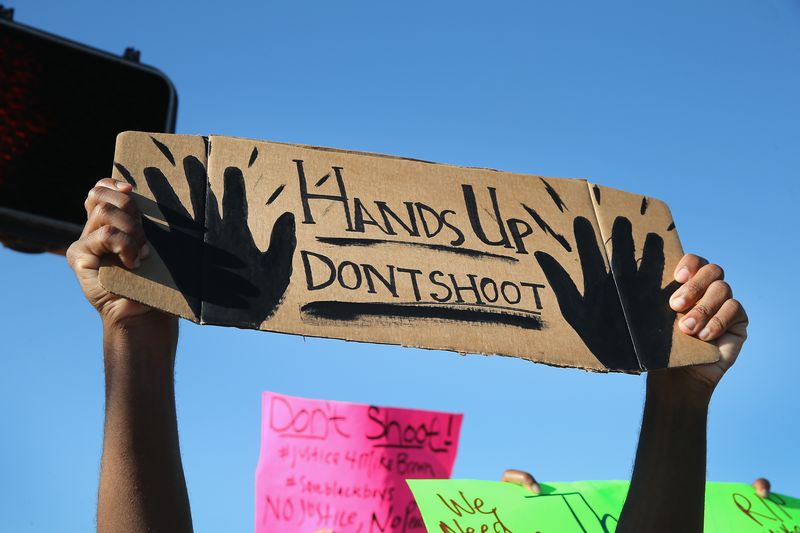 "Hands up, don't shoot" became the motto of the Ferguson protests after eyewitnesses said Michael Brown tried to surrender before Darren Wilson fatally shot him.