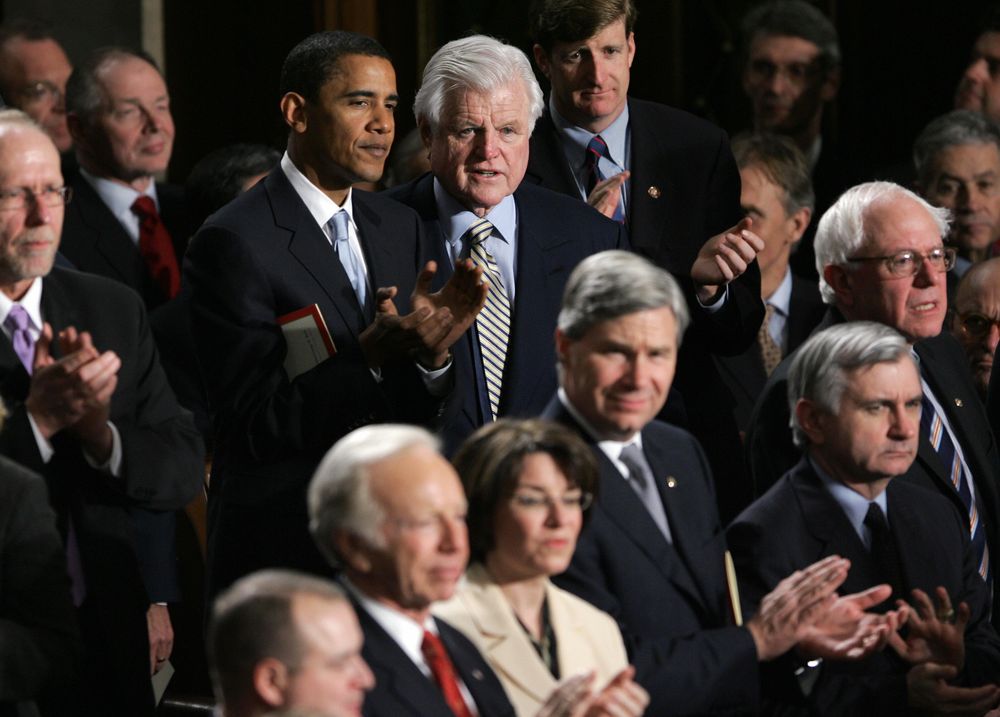 Then Sen. Barack Obama speaks with Ted Kennedy at the 2007 State of the Union address. Kennedy would endorse Obama over Hillary Clinton a year later. (Mannie Garcia / AFP / Getty)