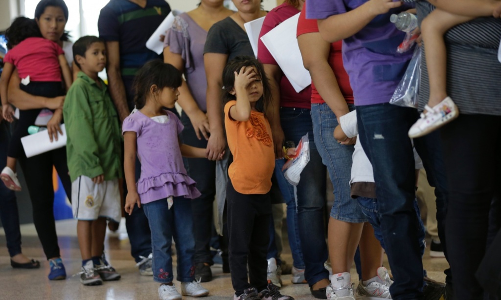 Immigrants who entered the US illegally stand in line for tickets at a bus station after being released from a US Customs and Border Protection processing facility in McAllen, Texas. Entering the US legally is not much easier for Latin American immigrants, who face a rejection rate of around 33%. Photograph: Eric Gay/AP