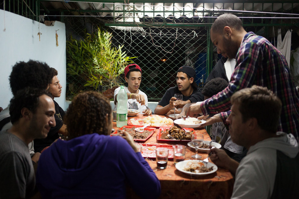 Miles Jackson, (standing, right) along with Bill Minadeo (sitting, right) from California Skateparks, at a family dinner with local skateboarders in Havana.