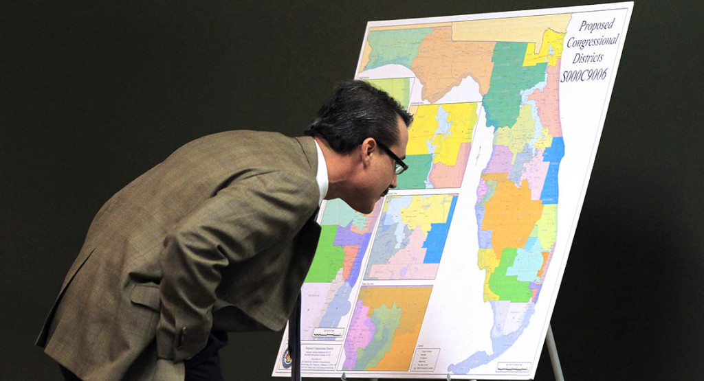 Florida Sen. Rene Garcia, R-Hialeah, looks at a map for proposed changes in Congressional districts during a Senate committee meeting on reapportionment, Wednesday Jan. 11, 2012 in Tallahassee, Fla. (AP Photo/Chris O'Meara)