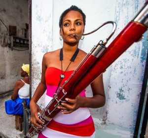  A pretty musician practices the bassoon outdoors.